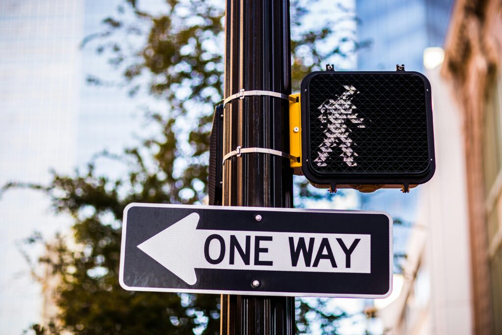 Shallow Focus Photo of Road Sign on Pole